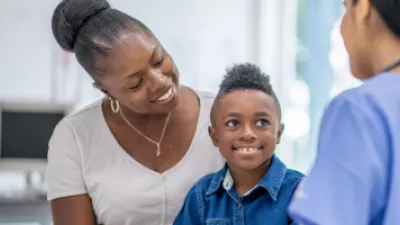 Mother and young son talking to provider in doctor's office