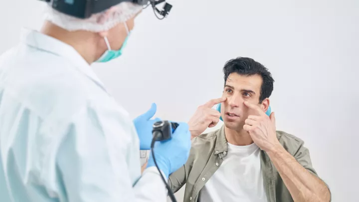 Man talking to ENT doctor