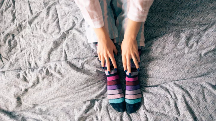 Close up of a woman's legs in bed