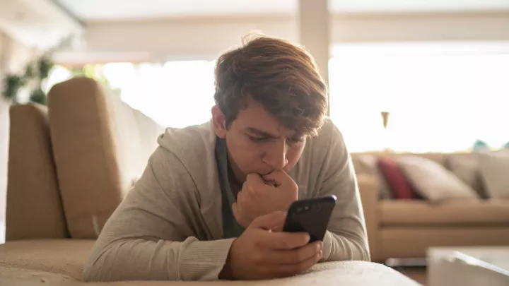 Teenage boy looking at his phone