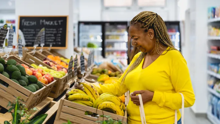 Women shopping produce in grocery store
