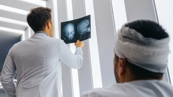 Doctor showing patient xray of skull