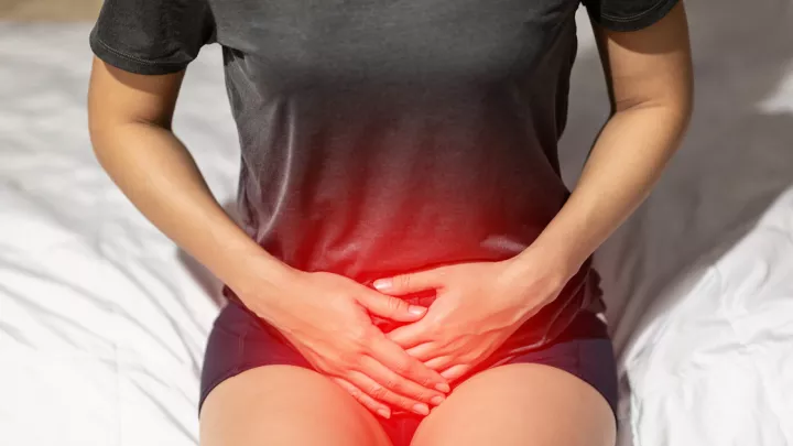 Close up of woman holding pelvis in pain